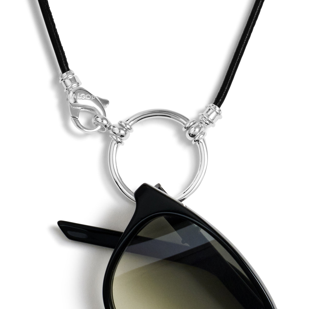 The Georgie 21 in black Italian leather, sunglasses resting in its silver loop beside the clasp
